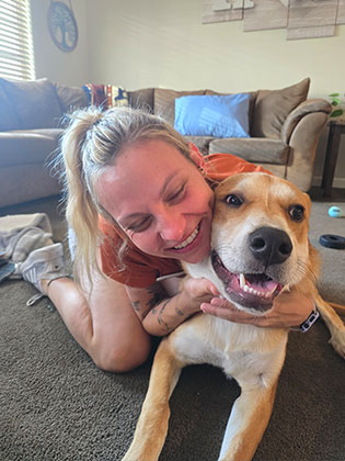 Veterinarian holding a small, happy dog